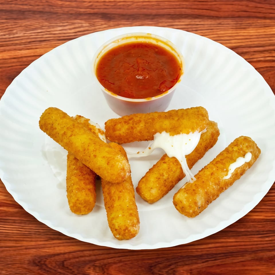 Golden-brown mozzarella sticks with melted cheese and a side of marinara sauce on a white plate.